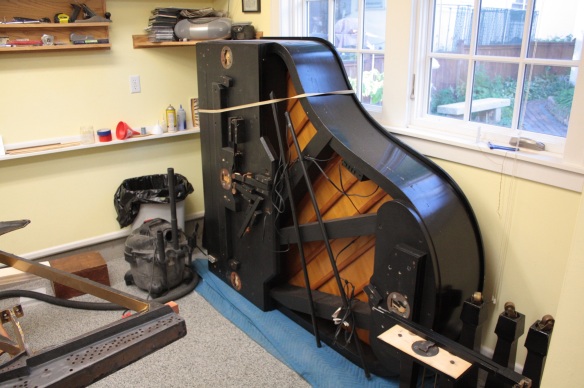 A concert piano doing an impression of an upright in Mark's workshop.