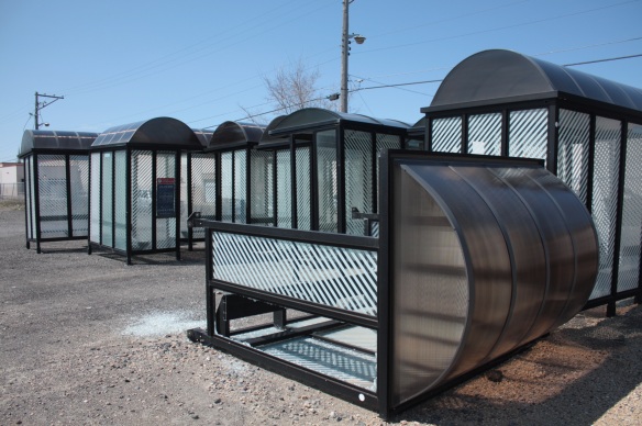 It's not just buses. Surplus bus shelters sit…and lay…ready for disposal.
