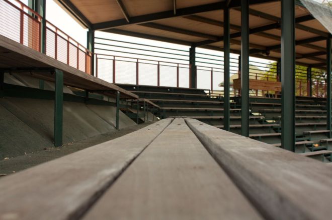 A look-see along the bleachers toward the middle of the stadium. The wood table on the right background is the press area.