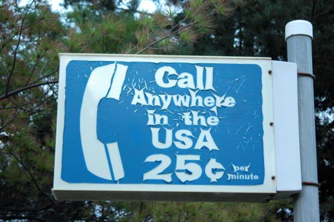 The payphone is long gone but this once-common sign still hangs on a pole above the parking lot at Mickey’s “By Willie.”