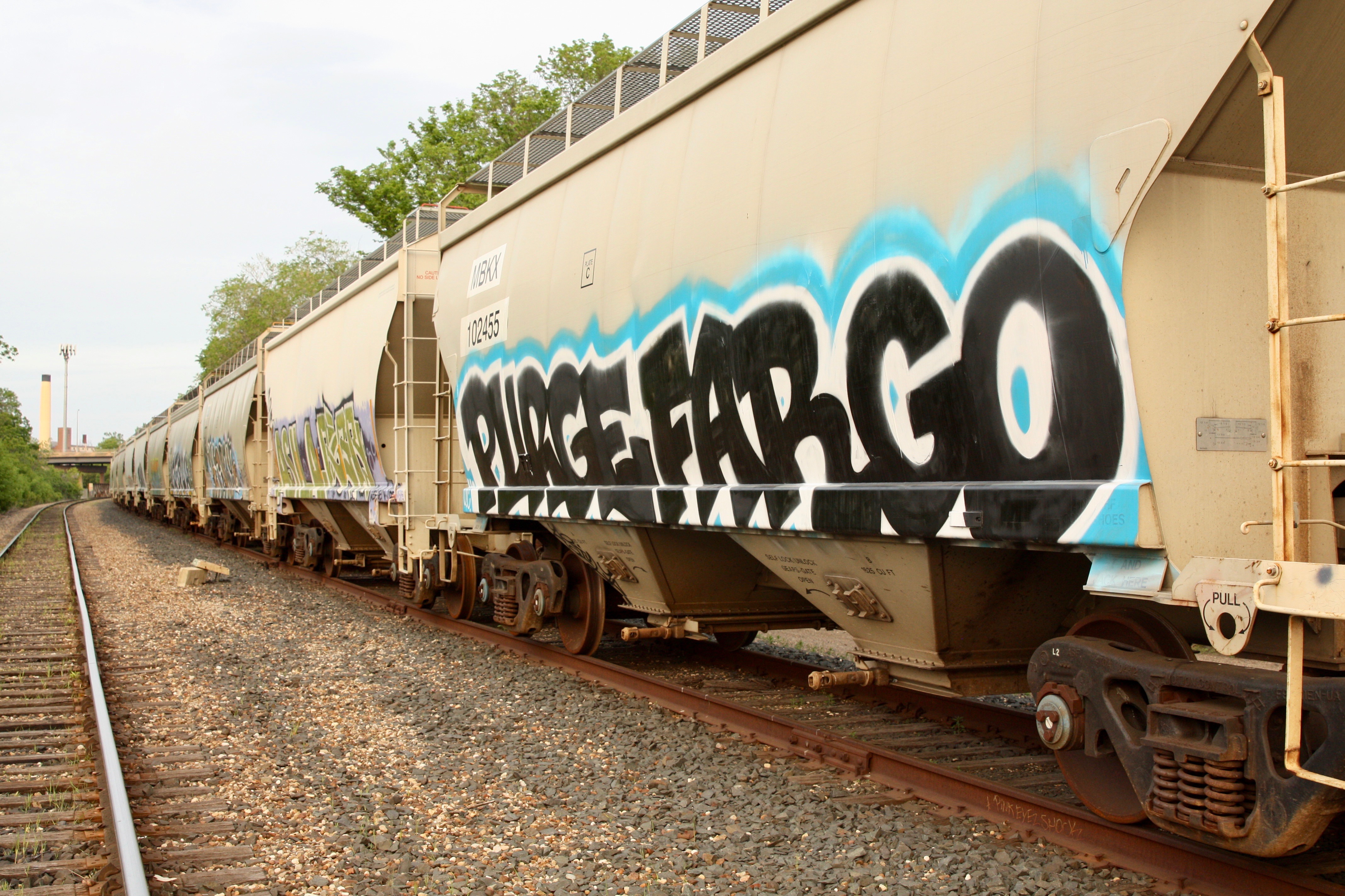 Most of the railroad cars have been tagged, many on both sides. The smokestack on the far left of the picture is the WestRock plant.