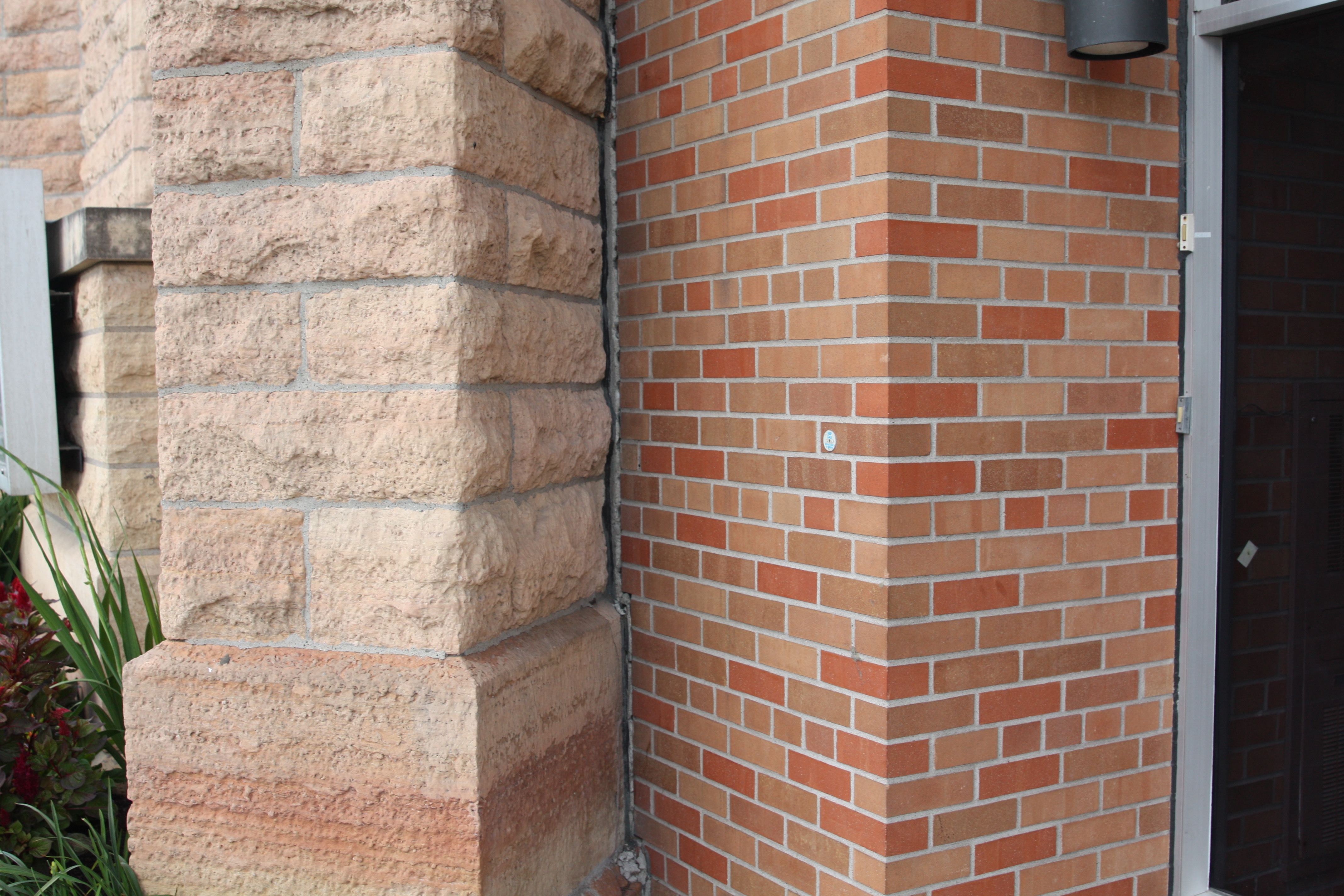 The stone work of 1875 building and the brick of the 1967 addition meet on the Wacouta Street side.