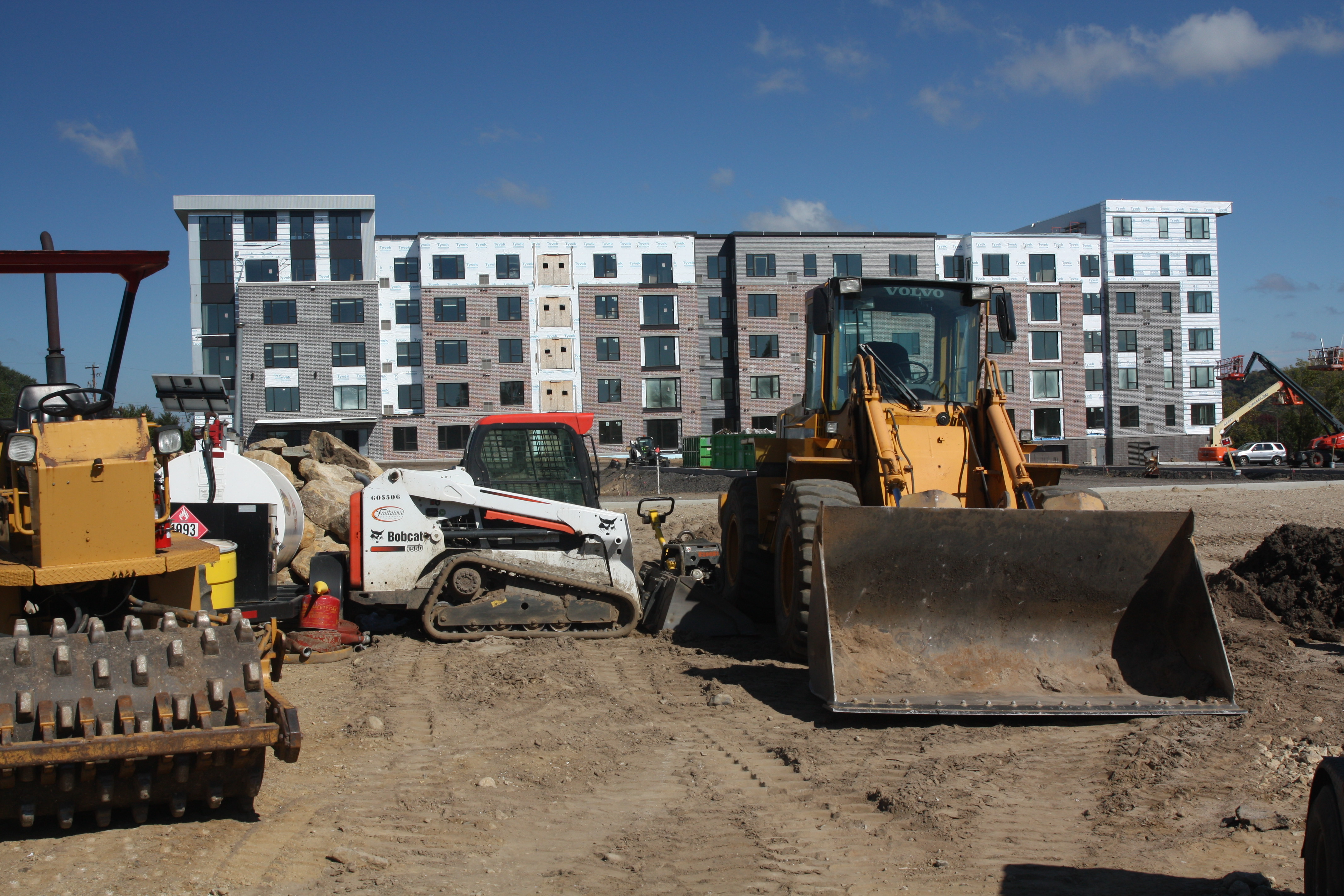 Construction equipment was parked in a way to reduce the chance the Bobcat or trailer with the white tank would be stolen. The V2 Apartments are in the background.